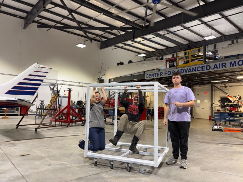The team with the fabricated and painted mobile steel test-box frame